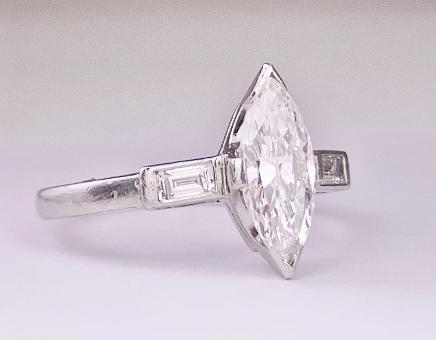 (Circa 1950s) Ring Platinum | Marquise G VS Clarity Dia .75 carats SD .12ct