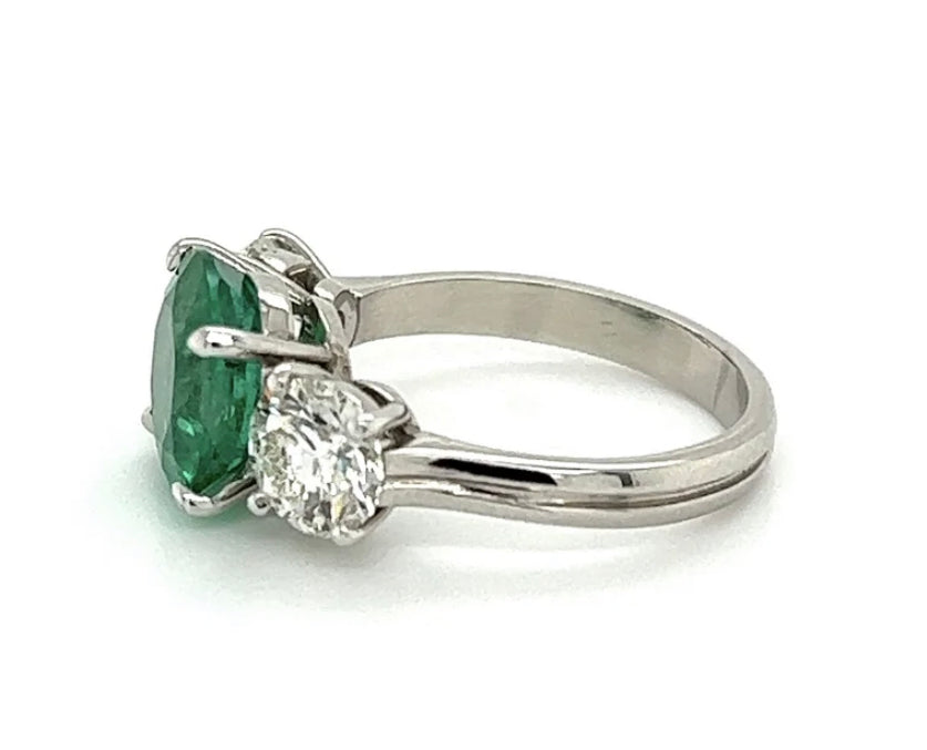 3.20ct GIA Zambian F2 Emerald .91ct GIA I SI1 Diamond .94ct GIA I SI1 Diamond Platinum Three Stone Ring